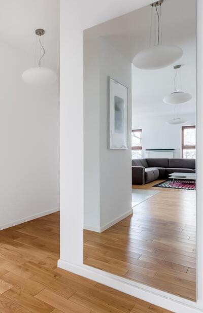 Brede spiegel op maat hangend aan de muur